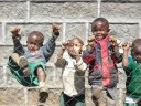 kids climbing on fence